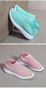Close-up detail view of breathable knit slip-on sneakers in mint green and dusty pink