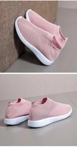 Close-up of lightweight pink fly-woven sneakers featuring breathable knit and white soles