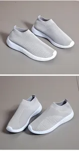 Detailed view of breathable grey fly-knit slip-on sneakers with white textured soles