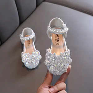 Elegant silver sparkling princess shoes for girls featuring a large butterfly rhinestone design