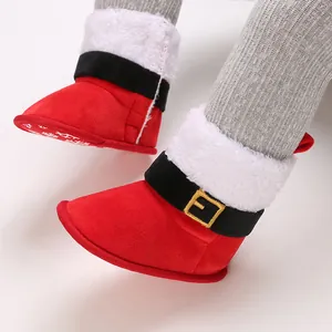 Detalle de los festivos botines rojos de Navidad para bebé con pelo blanco suave