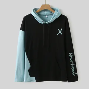 Close-up of a men's black and light blue color-block hoodie with letter print on sleeve