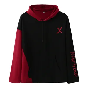 Detail view of men's hooded sweatshirt with red color blocking and trend printing