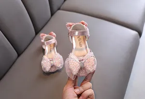 Gros plan sur les chaussures de princesse roses avec un nœud papillon en strass