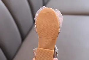 Detail view of the durable non-slip rubber sole on a pink girl's princess dress shoe size 26