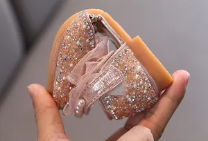 Detail view of the flexible soft sole on this sparkly rose gold girl's princess shoe.