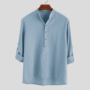 Detail of light blue men's cotton shirt with stand collar and textured fabric