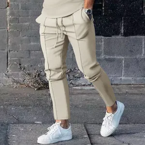 Stylish men's beige autumn joggers featuring a drawstring waist and unique vertical seam details