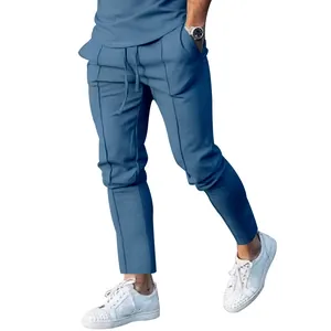 Detail view of men's blue slim-fit casual trousers with drawstring waist.