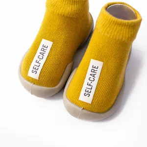 Soft knit baby walker sock shoes in yellow with flexible rubber soles for infants