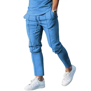 Detailed view of men's slim-fit light blue casual pants with vertical seam pleats.