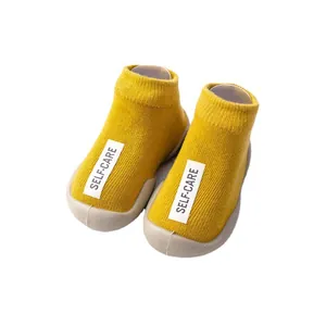 Soft sole yellow baby toddler sock shoes with comfortable knit upper and fabric label