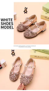 Close-up detail of girls' rose gold glitter princess shoes with bow and pearl strap