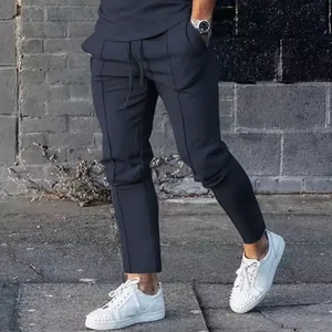 Detail view of men's slim fit navy casual pants featuring vertical pleated seams and drawstring