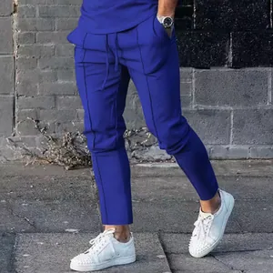 Detailed view of men's slim-fit royal blue joggers with vertical seam accents