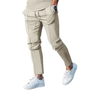 Detailed view of beige men's slim fit casual pants featuring unique vertical seam design