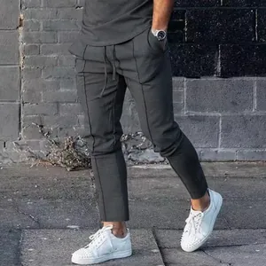 Side view detail of men's slim fit dark grey joggers with front seam design