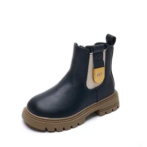 Classic black children's Martin boots with thick soles and gold-tone hardware detail