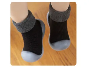 Detailed view of warm baby sock shoes with grey lamb wool cuff and soft rubber sole