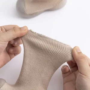 Detailed macro view showing high elasticity of the ribbed knit on warm baby floor shoes.