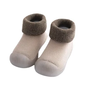 Warm winter baby sock shoes featuring a lamb wool collar and soft non-slip rubber sole.