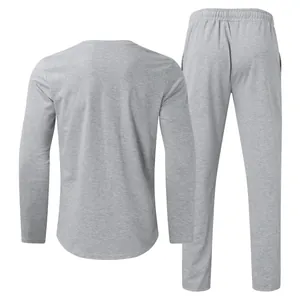 Back view of men's minimalist heather gray long-sleeved t-shirt and matching sports trousers