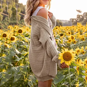 Stylish women's beige lantern sleeve knitted cardigan sweater set in autumn sunflower field
