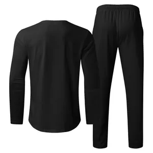 Back view of men's minimalist black long sleeve t-shirt and trousers lounge set