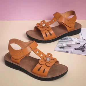 Stylish brown kids sandals with flower gems and anti-slip soft soles for beach.
