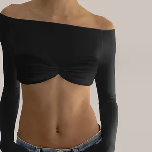Detail view of black off-the-shoulder long sleeve cropped top with twisted pleated chest