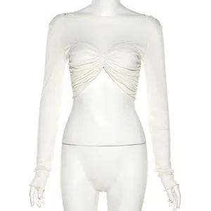 Detail view of slim fit long sleeve crop top with pleated front design in cream.