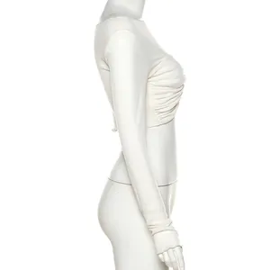 Side view of white long sleeve cropped T-shirt with delicate ruched texture details.