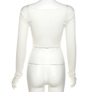 Detailed back view of a minimalist white slim-fit long-sleeve crop top for women