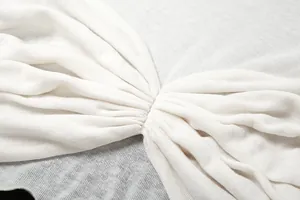 Close-up detail of the gathered pleat design on white long-sleeve knit cropped T-shirt
