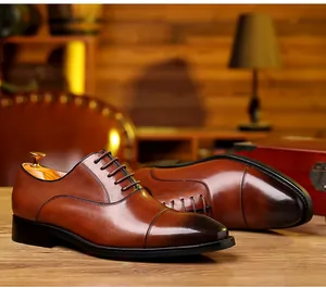 Classic brown genuine leather cap-toe oxford shoes for men in a professional setting