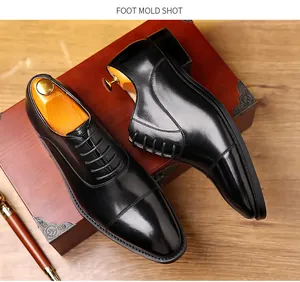 Close-up detail shot of classic black leather cap toe oxford shoes with wooden shoetrees