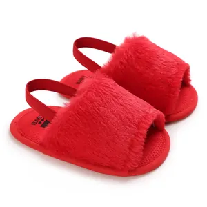 Red fuzzy baby sandals with elastic back strap for infant girls learning to walk.