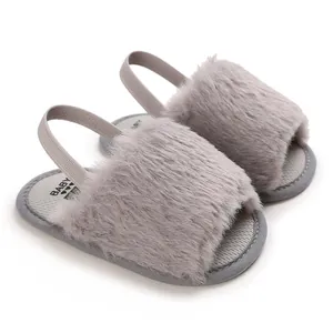 Close-up of fluffy grey faux fur baby sandals with a comfortable elastic heel strap.