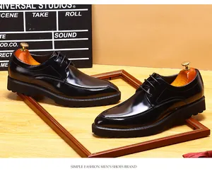 Close-up of polished black men's Derby shoes with thick soles and pointed toe design