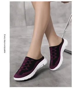 Close-up of women's purple fly-knit slip-on mules with white soles for casual daily wear