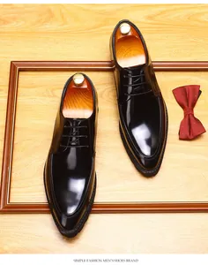 Top view of black pointed-toe leather Derby shoes with wooden shoe trees