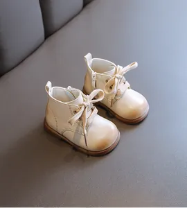 Classic beige leather baby boots featuring a soft sole and lace-up design for toddlers