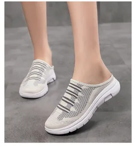 Detail view of breathable flyknit mesh upper on women's slip-on mule sneakers.