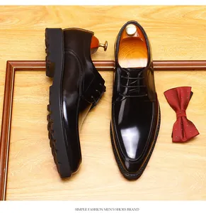 Men's black leather Derby shoes with pointed toe and thick sole on wooden background