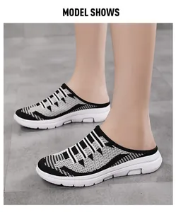 Close-up of women's breathable fly-knit slip-on mule sneakers in black and white