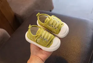 Primer plano de zapatos de lona verdes para niños con tela transpirable y suela de goma