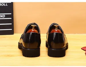 Rear view of black leather men's Derby shoes showing the thick lug sole and heel.