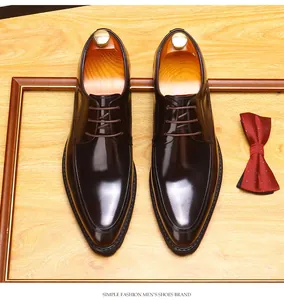 Detailed top view of polished dark brown men's leather Derby shoes with shoe trees.