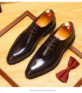 Detailed macro view of polished brown leather men's derby shoes on a wooden background