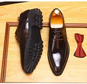 Detailed macro view of men's burgundy leather Derby shoes featuring a thick rubber lug sole